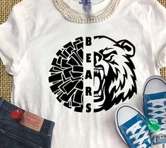 a t - shirt with the word bears printed on it next to shoes and pearls