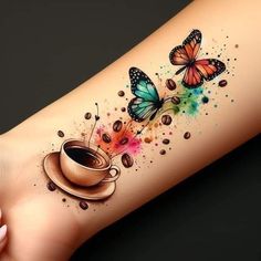 a woman's arm with coffee and butterflies on it