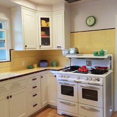 a white stove top oven sitting inside of a kitchen