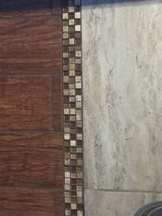 a bathroom with a toilet and tiled flooring next to a shower head mounted faucet