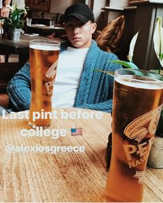 a man sitting at a table with two beers in front of him and the caption that reads, eat pint before college alexiosgrereece