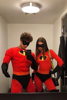 two people dressed as the incredibles are taking a selfie in front of a mirror