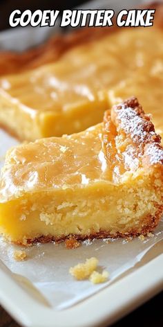 two pieces of gooey butter cake on a plate with the words gooey butter cake