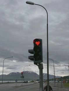 a red traffic light sitting on the side of a road