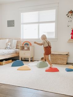 a toddler playing with toys in his bedroom