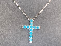 Sterling Silver Turquoise Stone Cross Necklace Easy - Wearing Stylish design   925 sterling silver delicate chain with turquoise stone cross pendant Cross charm slides freely along the length of the chain Ideal for every day wear  Highest quality guaranteed 925 sterling silver (92.5% pure silver)  Specifications:    Color: Silver   & Turquoise Blue Material: 925 sterling silver & Turquoise Stone    Dimensions of cross: 17 mm x 12 mm approximately Length of necklace: 40 cm + 5 cm extension approximately Package Includes: 1 x cross necklace with complimentary jewellery pouch Turquoise Cross Pendant Necklace As Gift, Turquoise Cross Pendant Necklace For Gift, Turquoise Cross Sterling Silver Necklace, Turquoise Cross Necklace In Sterling Silver, Turquoise Sterling Silver Cross Necklace, Sterling Silver Cross Necklace With Gemstone, Blue Pendant Cross Necklace Gift, Elegant Turquoise Cross Jewelry, Turquoise Sterling Silver Cross Pendant Jewelry