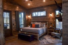 a bedroom with wooden walls and ceiling lights