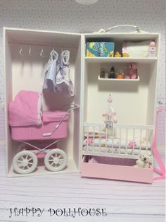 there is a dollhouse with a baby's crib in the closet and a pink stroller