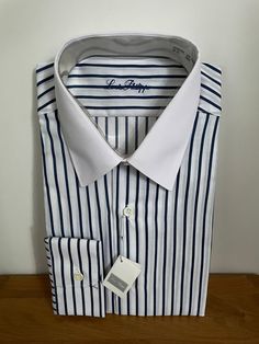 "Vintage unworn white shirt with dark blue stripes and solid white collar in polyester cotton mix by Louis Philippe of Savile Row.  Details: spread collar, long sleeves, single cuff, regular fit.  Size 15\" 38cm S/M" Business Dress Shirt With Striped Collar And Long Sleeves, Business Dress Shirt With Striped Collar, Business Long Sleeve Dress Shirt With Striped Collar, Business Pinstripe Dress Shirt With Spread Collar, Classic Long Sleeve Dress Shirt With Vertical Stripes, Pinstripe Dress Shirt With Spread Collar For Business, Semi-formal Striped Collared Dress Shirt, Striped Collared Dress Shirt For Semi-formal Occasions, Semi-formal Pinstripe Long Sleeve Dress Shirt