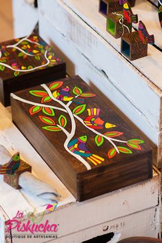 wooden boxes with painted designs on them