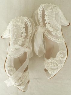 "Ivory lace embellished wedding shoes for bride and bridesmaids, with low heels. These shoes compliment your ivory lace wedding dress beautifully! Custom wedding gift, personalized engagement gift, bridesmaids shoes. Ivory bridal shoes are designed with embroidered lace. Glass beads, shiny sequins and small pearls are used on the embroidery. Organza ribbons tie on the front. Custom details can be added on this design, soles can be personalized with your names and wedding date. They are made of s Lace Wedding Shoes, Wedding Shoes For Bride, Shoes For Bride, Ivory Bridal Shoes, Ivory Lace Wedding Dress, Heels Vintage, Personalized Engagement Gifts, Wedding Shoes Lace, Wedding Boots