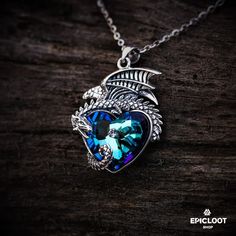 925 Silver Dragon guards a blue crystal heart necklace. – Epic Loot Shop Spiritual Blue Heart Pendant Necklace, Sterling Silver Spiritual Necklace With Dragon Design, Mystical Blue Sterling Silver Necklace, Spiritual Sterling Silver Necklace With Dragon Design, Blue Spiritual Heart Pendant Jewelry, Spiritual Blue Heart Pendant Jewelry, Blue Heart-shaped Spiritual Necklace, Blue Mystical Pendant Jewelry, Mystical Blue Pendant Jewelry