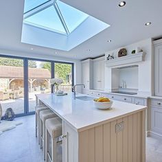 a large kitchen with an island and skylight