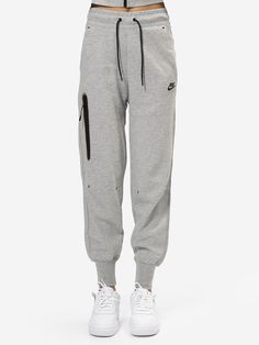 The Nike Sportswear Tech Fleece trousers are an excellent choice for those who want a casual yet sporty look. Made of soft fleece fabric, these trousers offer comfort and elegance. The waist is equipped with an elasticated drawstring, as are the elasticated ankles which ensure a snug fit.   Elastic waist with drawstring  Side pockets  Zipped pocket  Elastic ankles    Fit: Fit regular The model is 175 cm tall and wears size XS Nike Tech Pants, Nike Tech Joggers, Nike Tech Fleece Tracksuit, Drippy Fits, Nike Tech Fleece, Nike Tech, Tech Fleece, Tracksuit Women, Look Casual