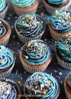 many cupcakes with blue frosting and sprinkles