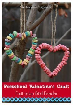 two heart shaped cookies hanging from a tree branch with the words preschool valentine's craft