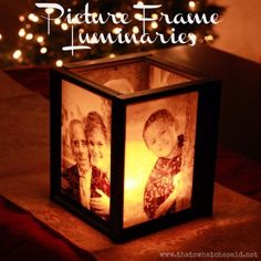 a candle holder with two pictures of people on it and the words anniversary written in white