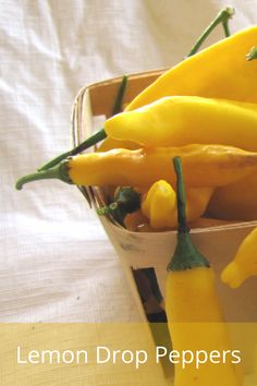 lemon drop peppers in a white bowl on a tablecloth with the words lemon drop peppers