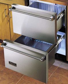 two stainless steel drawers in the middle of a kitchen