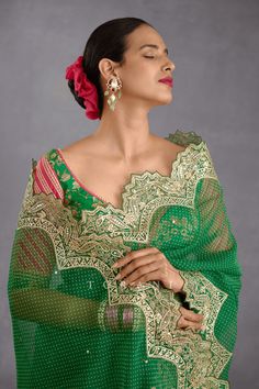 Editor's Note Featuring a rich green silk organza saari finished with scallop border along with bhagalpuri printed sweetheart neck blouse Color: Green Fabric: Silk organza Components: Sari and blouse Fit: Fitted at bust Occasion: Haldi mehndi and wedding guest Care: Dry Clean Only About the Designer Torani by Karan Torani stands handcrafted luxury inspired by the myriad tales of Indian mythology. Torani is a potpourri of all things nostalgic that binds you with a memory long forgotten. The label Sweetheart Neck Blouse, Blouse Yoke, Tuxedo Accessories, Scallop Border, Photo Awards, Indian Textiles, Rich Green, Organza Saree, Fancy Sarees