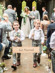 a little boy walking down the aisle at a wedding