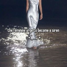 a woman in a silver dress walking through water with the caption, the feminine urge to become a siren