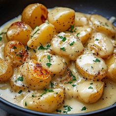 a bowl filled with potatoes covered in gravy