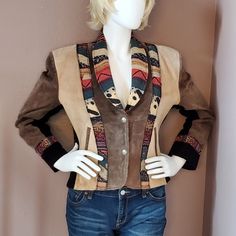 Shell: Genuine Leather. Lining: 100% Acetate Satin. Jacket Is Pieced Together With 3 Colors Of Leather: Taupe, Beige And Black. Trimmed With A Southwestern Style Fabric. Jacket Has Built-In Shoulder Pads And 2 Front Pockets. 2 Silver Colored Snap Closure In Front. Left Bottom Front Has A Small Pin Mark. Right Bottom Front Needs To Be Cleaned. In Overall Great Condition. Chest: 23", Waist: 21", Bottom Width: 22", Sleeve Length: 24", Length From Shoulder To Hem: 22" Mannequin Measures 37" Bust, 29 Southwestern Jacket, Wrangler Cowboy Cut, Aztec Style, Black Mock Neck, Aztec Fashion, Satin Jacket, Beige And Black, Small Pin, Native American Fashion