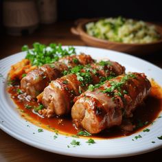 a white plate topped with meat covered in sauce