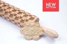 a wooden carving knife with carved sheeps on it's blade and the words new pattern below