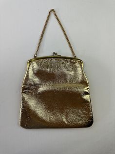 "She fancy - THE DETAILS: Polished shiny metallic gold in color, chain handle, clasp closure, lined ~ Era: 60's ~ Material: man made leather - could be genuine leather but doesn't have tag stating it ~ Condition: Good  - no major flaws, stains on inside, outside is great (see photo) MEASUREMENTS (Flat Lay): ~ Height  8 3/4\" (excludes strap length) ~ Width 9\" ~ Depth 1\"  - Ships quickly - Message with questions - Shop with confidence - No surprises here -  Perfectly imperfect vintage charm may Chic Metallic Shoulder Bag For Evening, Metallic Rectangular Bag With Chain Strap, Metal Evening Bag With Chain Strap For Party, Gold Leather Evening Bag With Detachable Strap, Gold Leather Bag For Evening, Gold Leather Bag For Events, Metallic Evening Bag With Gold-tone Hardware, Chic Metallic Rectangular Evening Bag, Gold Leather Evening Bag