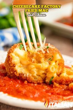 the cheesecake factory fried macaroni and cheese is being held by a fork