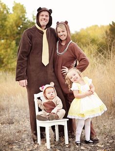 three children dressed up in costumes standing next to each other