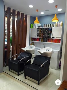 a salon with two sinks and chairs in it