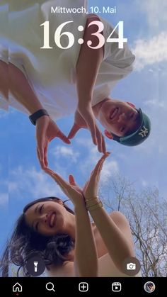 two people making a heart shape with their hands