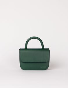 Our ever-popular mini bag, the Nano in a classic autumnal hue: Pine Green, for our FW24 collection. One of the smallest and most compact bags in our collection: The Nano Bag. This itty-bitty bag is all about the essentials. With enough space for your mobile phone, coin purse, lip balm and keys, the little Nano Bag makes a big statement. Featuring an inside zip pocket for extra security and a slip-in pocket for easy access. Her front flap closes with an inner magnet and her strap has a knob-button system to adjust the length. OMB-E137PGV Classic Green Shoulder Bag With Mobile Phone Holder, Classic Green Shoulder Bag With Phone Holder, Classic Green Mobile Phone Bag, Small Elegant Travel Bag, Small Elegant Bag For Everyday Use, Elegant Small Bag For Everyday Use, Everyday Top Handle Box Bag For Mobile Phone, Small Bags With Detachable Handle For Everyday Use, Small Bag With Detachable Handle For Everyday Use