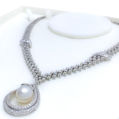 This exquisite 18k gold set, weighing 69.6 grams, features a stunning combination of diamonds and pearls, exuding luxury and sophistication. The yellow gold finish beautifully complements the sparkling diamonds and elegant pearls, making it perfect for any special occasion. The set includes a necklace adorned with 11.25 carats of F-G color, VS quality diamonds, and 24.87 carats of pearls. The necklace's length and drop length details are unspecified, but it is secured with a hook lock. The match Luxury White Diamond Necklace With Pearl Chain, Luxury Diamond Necklace With Pearl Drop, Luxury Diamond White Pearl Necklace For Wedding, Luxury Round Diamond Necklace With Pearl Pendant, Luxury Diamond White Pearl Drop Necklace, Luxury Diamond Necklace With Pearl Pendant, Luxury Brilliant Cut Pearl Jewelry, Wedding Pearl Necklace With Brilliant Cut Diamonds, Luxury Pearl Necklace With Diamond Accents