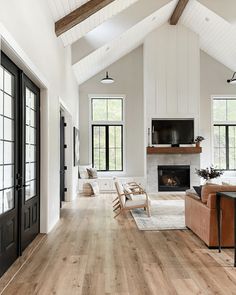 a living room filled with furniture and a fire place in the middle of a room