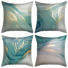 four decorative pillows with blue, gold and white designs on the front one is square