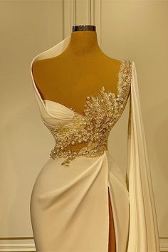 a white dress with gold details on it