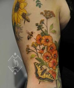 a woman's arm with sunflowers and butterflies on it