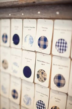 many cards are arranged in rows on the wall with blue and white checkered designs