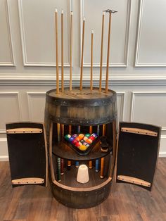 an old wooden barrel with many different items in it and two speakers on the side