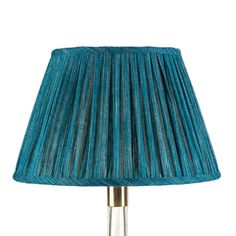 a green lamp with a gold base and pleated lampshade on the bottom