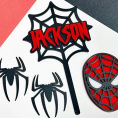 a spiderman mask and some cut outs on top of a white paper with the word jackson written in red