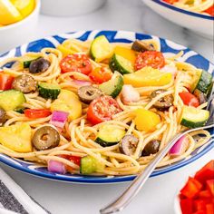 a blue and white plate filled with pasta salad