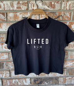 When you're a strong woman of God you know that all you have to do is trust that you have been lifted from your past to move forward. This workout crop top would be a great gift for the Christian woman in your life that loves lifting heavy and spreading the Word of God! This crop top is soft, lightweight, and flowy with a flattering cut and raw edge seams for an edgy touch. 4 oz./yd², 60/40 combed ringpspun cotton/polyester, 30 singles Retail fit 1x1 baby rib set-in collar and cuffs Drop shoulde Christian Crop Tops, Gym Tshirts For Women, Christian Gym Clothes, Strong Woman Of God, Christian Workout Shirts, Gym T Shirt Design, Gym Shirts For Women, Christian Workout Clothes, Christian Gym