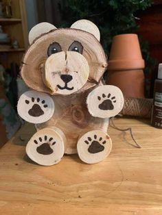 a bear made out of wood sitting on top of a table