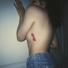 a woman with a red tattoo on her back