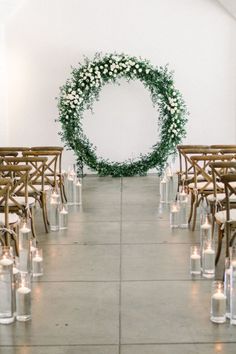 an aisle with candles and flowers on it